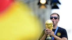 Capitão Philipp Lahm celebra com a taça da Copa do Mundo no Portão de Brandemburgo, em Berlim